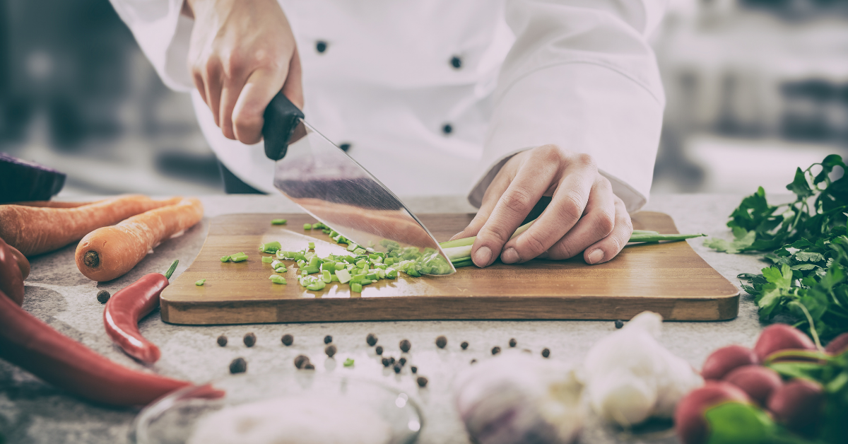 A cook preparing vegetables for a delicious dish