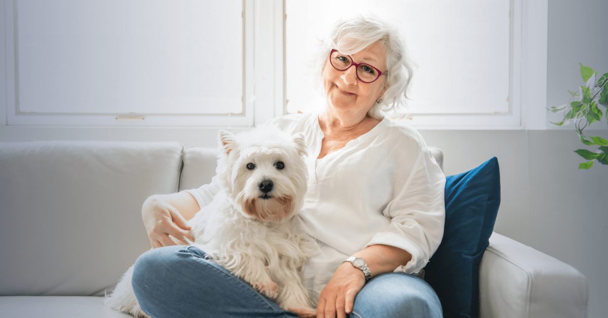 woman sitting on couch with dog