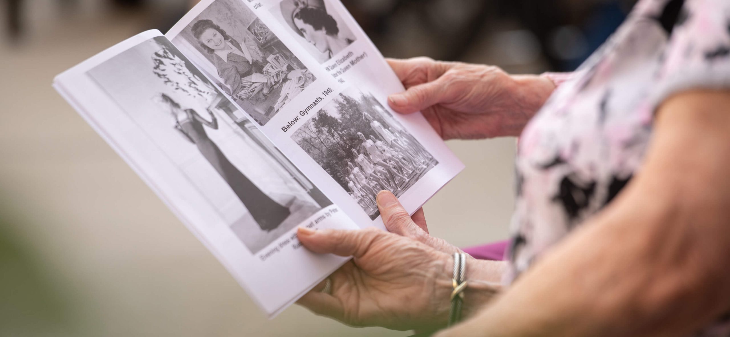 residents reading together an older magazine